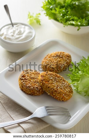 Healthy vegetable cutlets with carrot, dried apricots, almonds and herbs, breaded in oat bran