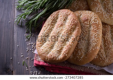 Flat bread with sesame seeds on wooden boards