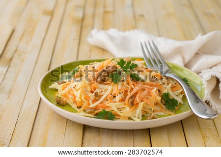 Celery salad with carrots, walnuts, parsley and with yogurt sauce on wooden boards