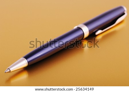 Blue pen on table. Macro shot with shallow depth of focus (on ballpoint).