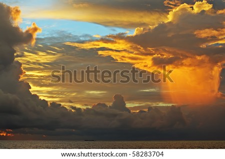 Fantastic sky (original colours) iluminated by the sunset light before the rain over the ocean. Maldives.