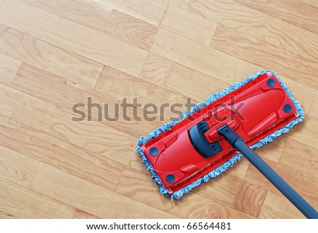 Cleaning laminate. Red mop on hardwood floors.