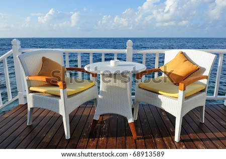 Table for two in water bungalow close to the ocean