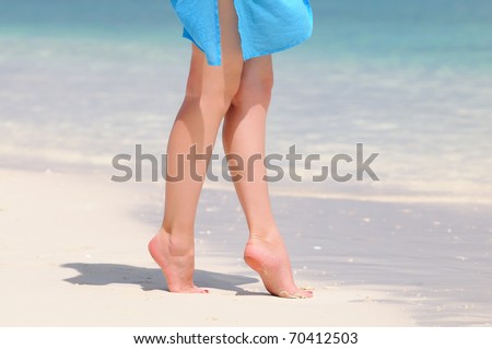 Pair of nice legs walking on a beautiful beach in Maldives