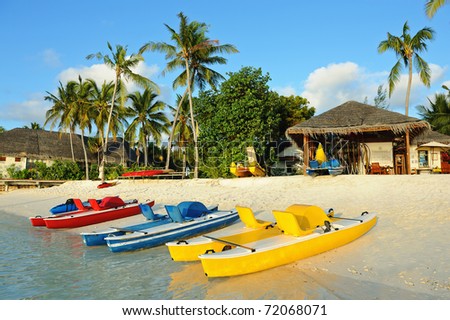 Water sports equipment on beach in warm sunlight