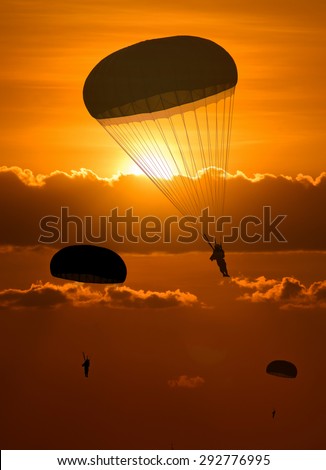 Silhouette Military parachute jump While Sunrise
