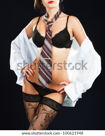 Sexy woman in erotic lingerie over dark background