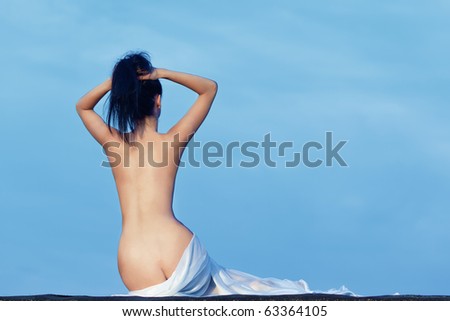 woman bare back sitting wrapped with white towel