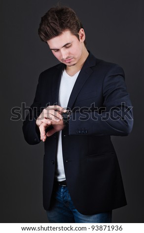 Business Man in Suit Pointing at Watch