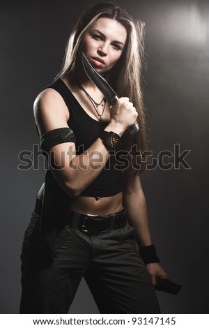 Sexy woman holding daggers with smoke
