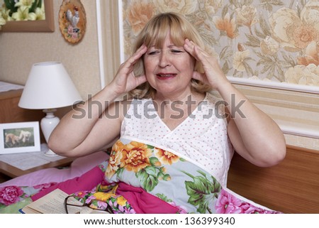 Old woman suffering with fever in the bedroom