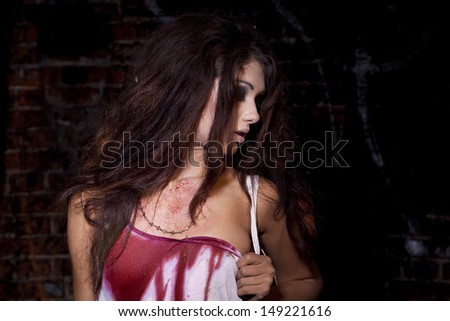 Sinister woman in a bloody shirt