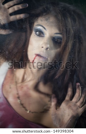 Frightened woman behind the glass