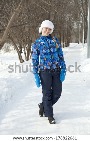 Young happy woman walking in winter day