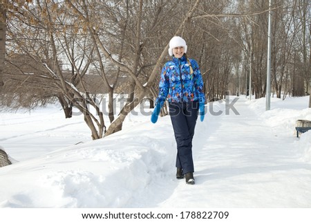 Young happy woman walking in winter day