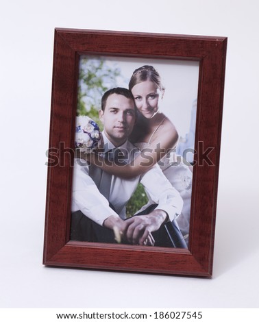 Newlyweds portrait in a wooden frame