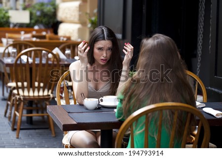 Two best friends solve their problems sitting in cafe