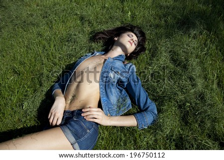 Portrait of young Sexy model in jeans clothes in summer park