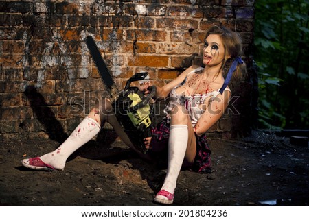 Psychotic woman with a chainsaw covered in blood