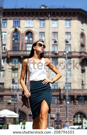 Young beautiful business woman with blue mirrored sunglasses
