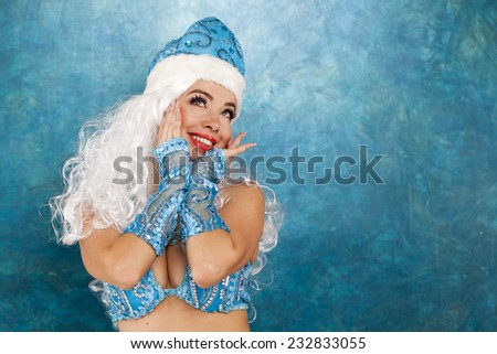 Sexy woman dressed in traditional russian christmas costume of Snegurochka (Snow Maiden), isolated on white background