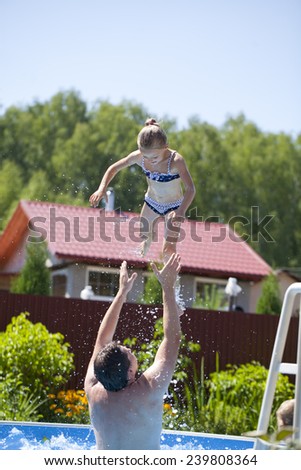 Happy family, active father with little child, adorable toddler girl swim in the pool