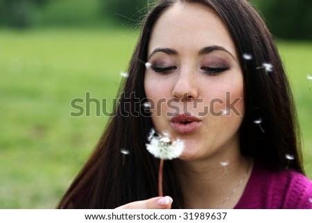 young girl with a dandelion in hands