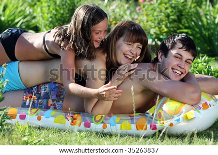 Young family from three person lay on an inflatable mattress