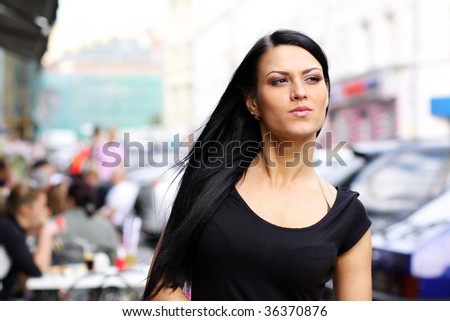 Closeup portrait of a happy young woman smiling  on urban background