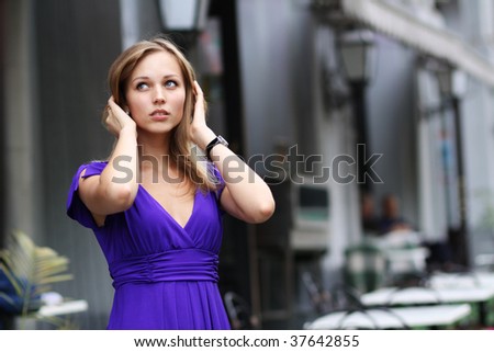 portrait of a happy young woman smiling  on urban background