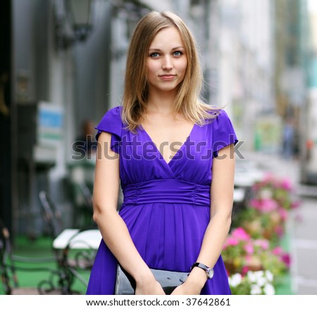portrait of a happy young woman smiling on urban background