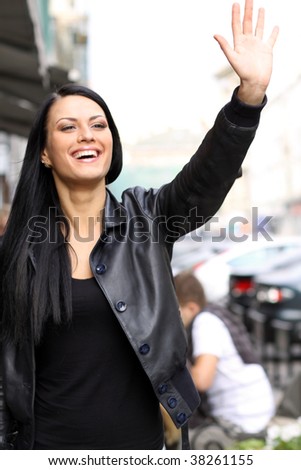 Closeup portrait of a joyful young woman smiling  on urban background