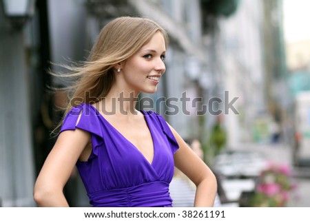 Portrait of a young woman smiling on urban background