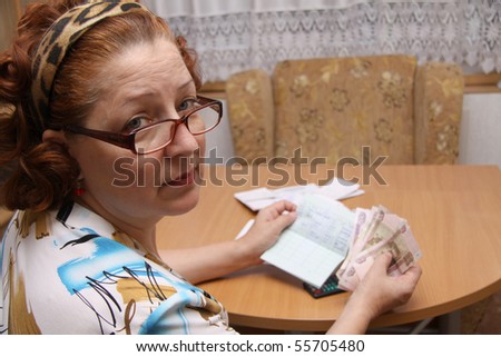 old woman counts money