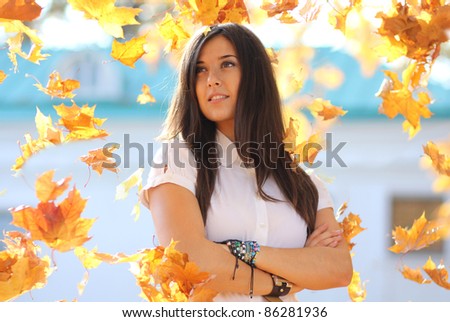 Portrait of a happy woman against yellow leaves