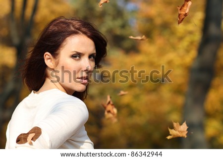 Portrait of a happy woman against yellow leaves
