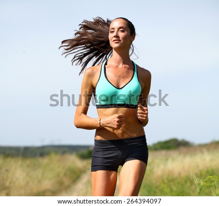 Happy young Woman Runner. Fitness Girl Running outdoors
