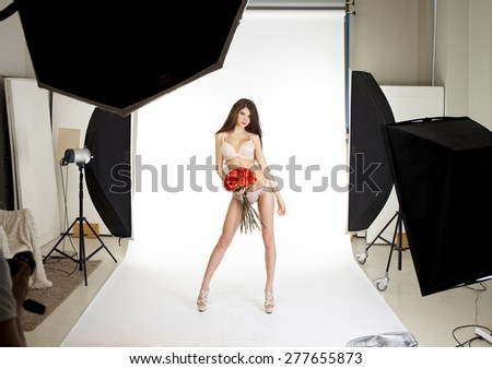 Conditions of work in the studio, a professional model posing in photo studio
