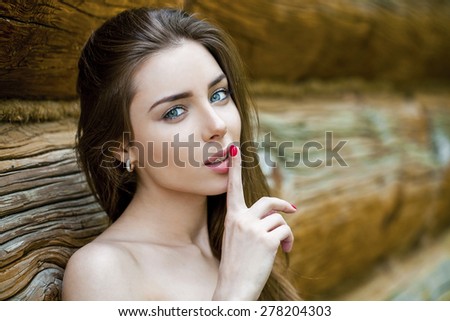 Portrait of attractive girl with finger on lips, concept of student show quiet, silence, secret gesture, young pretty brunette woman