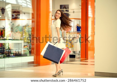 MOSCOW, RUSSIA - CIRCA MAY 2015: A young girl walks around the store with shopping bags in her hands at Shopping center \