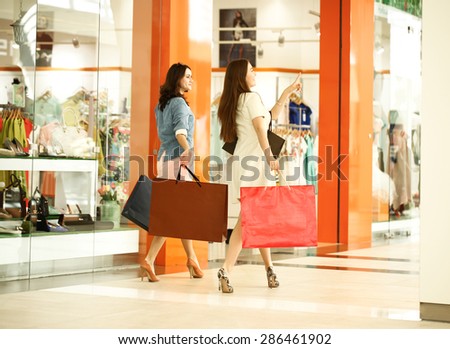 MOSCOW, RUSSIA - CIRCA MAY 2015: Two young girls walk around the store with shopping bags in their hands at Shopping center \