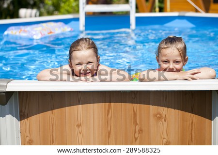 Two Happy sisters in bikini swimming pool