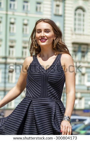 Close up Portrait, Young beautiful blonde woman in black dress posing outdoors in sunny weather