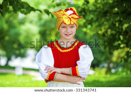 Close up Little girl is dressed in the Russian national dress Ã?Â??Ã?Â?? summer park