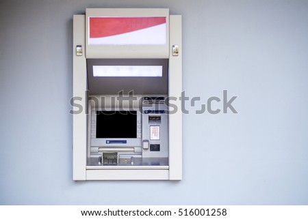 ATM in the mall without people, gray wall outdoors