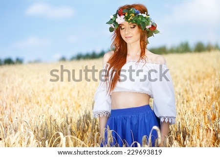 Redhead girl in a field of rye