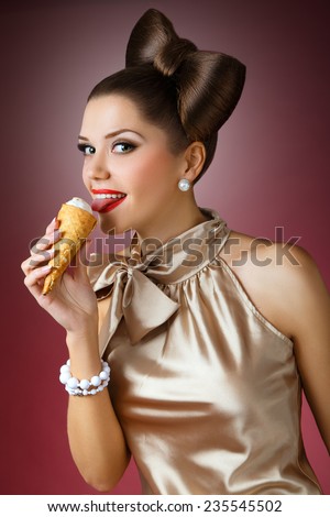 pretty girl licking ice cream and smiling. Pin-up girl, burgundy background, beautiful hairstyle