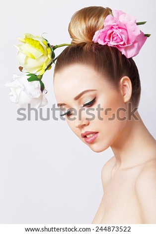 Fashion Beauty Model Girl with Rose Flowers Hair. Make up and Hair Style. Hairstyle. Nude makeup. Bouquet of Beautiful Flowers on lady\'s head. isolated on white