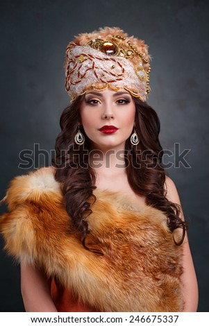 Beautiful haughty queen in royal dress. sexy girl in royal hat and fur coat. Luxury woman in traditional dress