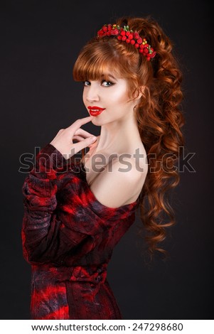 sexy beautiful redhead girl with long curly hair and a red dress.hair ornament.red lips. long thick bangs